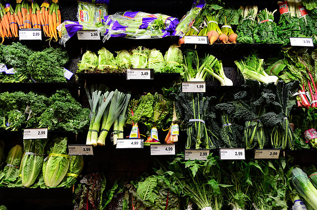 Vegetables on a shelf at a supermarket.