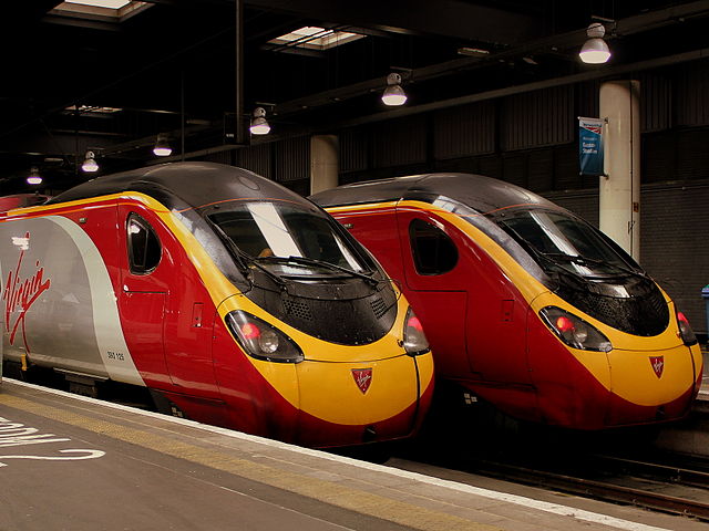 Virgin Branded trains side by side at station.